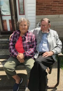Jimmy and Minnie Jones sitting together on a park bench